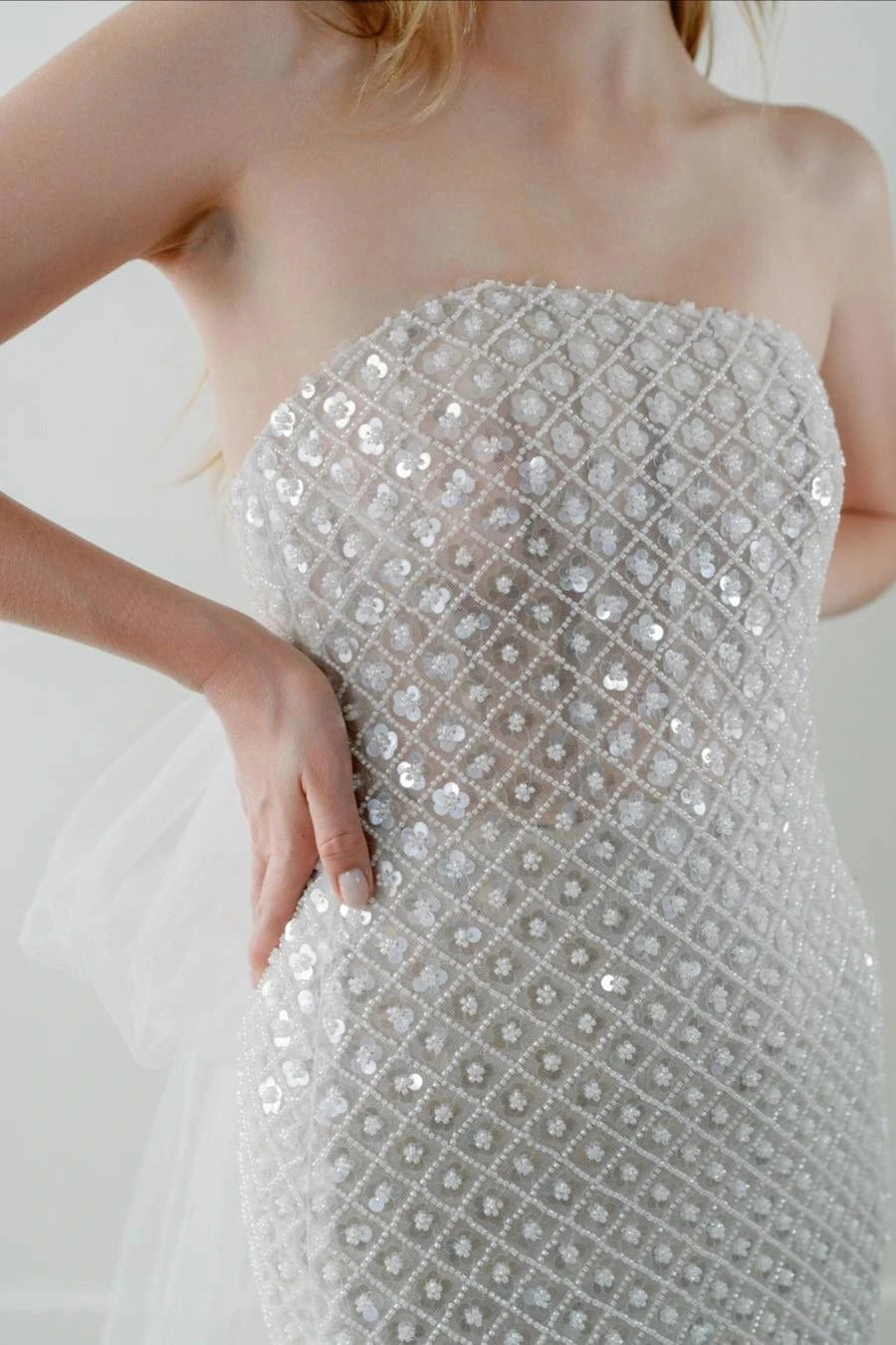 close up of watters ondrea ivory beaded fitted wedding dress, showing the strapless neckline