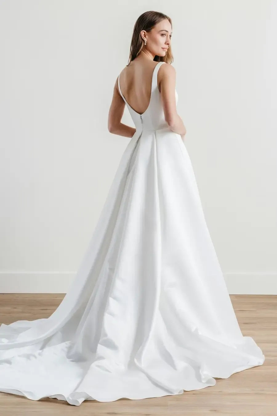 full back of locket by watters paketti ivory satin wedding dress with a square neckline and pockets in the skirt
