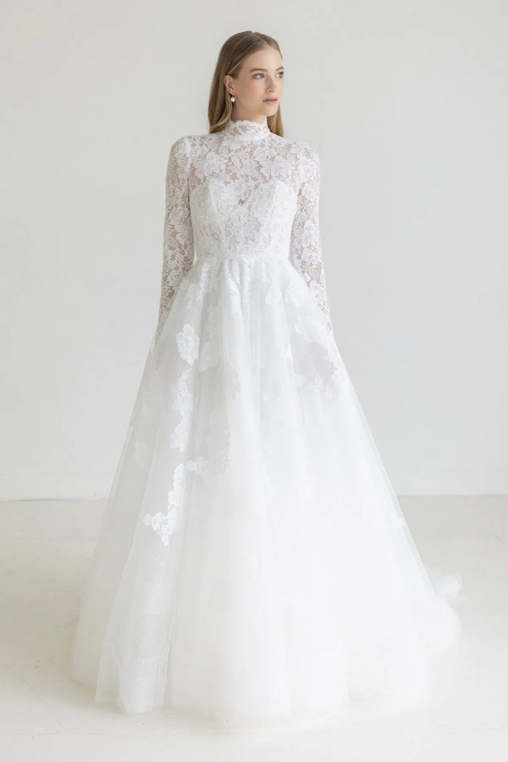 White wedding dress with lace detailing on a white background