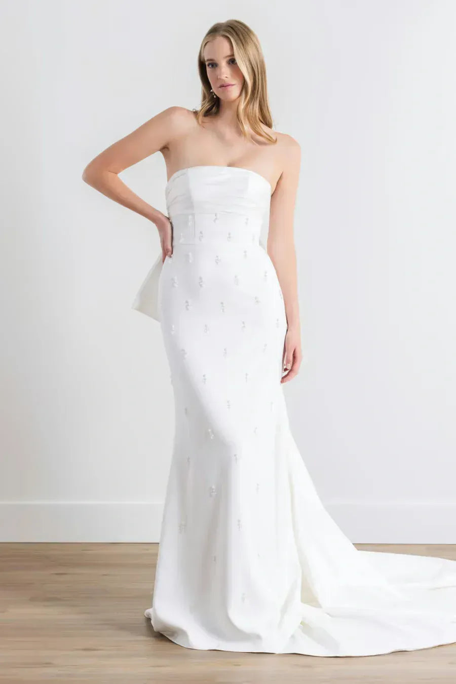 full front of watters sanora ivory crepe fitted wedding dress featuring a strapless straight neckline + scattered beading