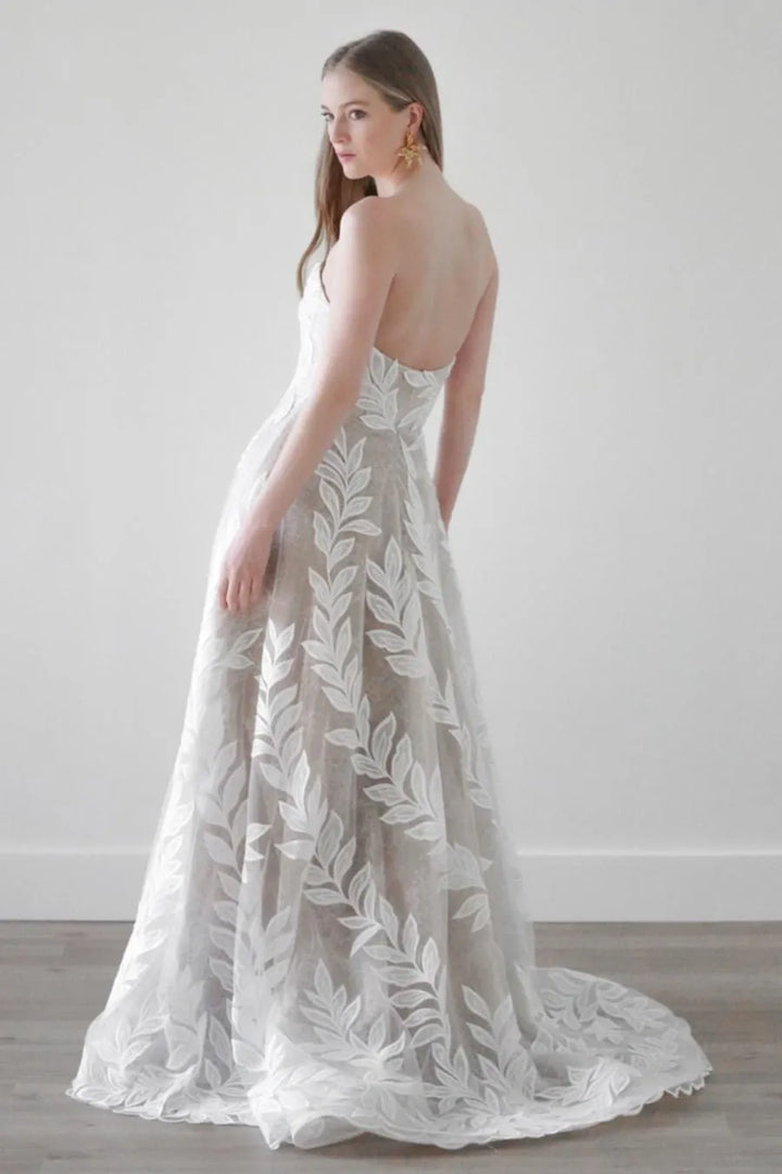 full back of watters soraya ivory tulle a-line wedding dress featuring an oversized floral print and short train