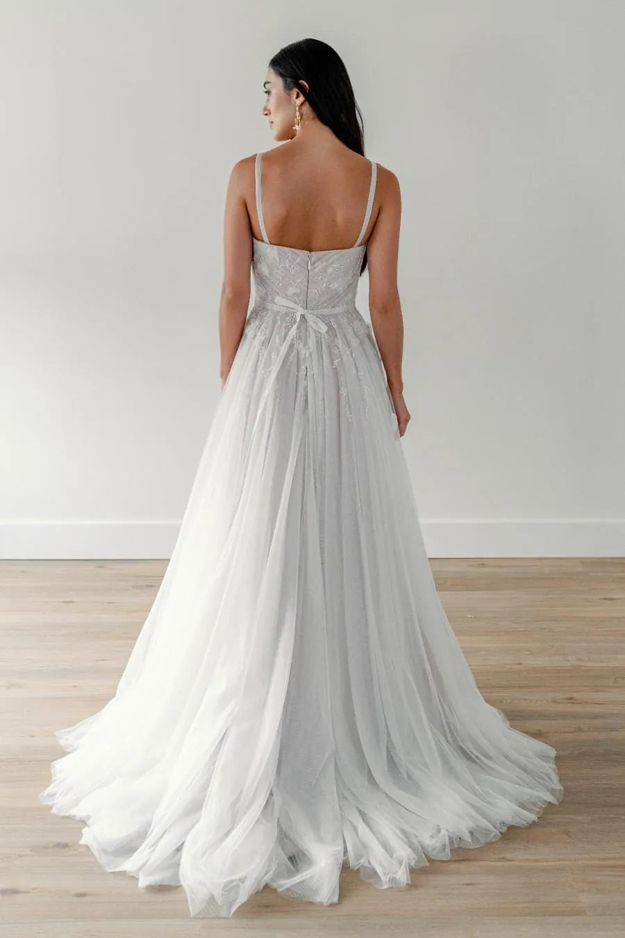 back of willowby by watters champagne tulle a-line wedding dress with appliques on the bodice and a short wispy train