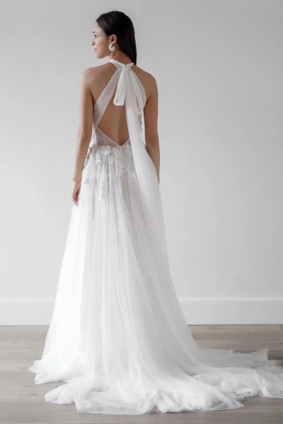 full back of willowby alessandra nude tulle a-line wedding dress with a sheer halter style neckline, open back, and floral motifs