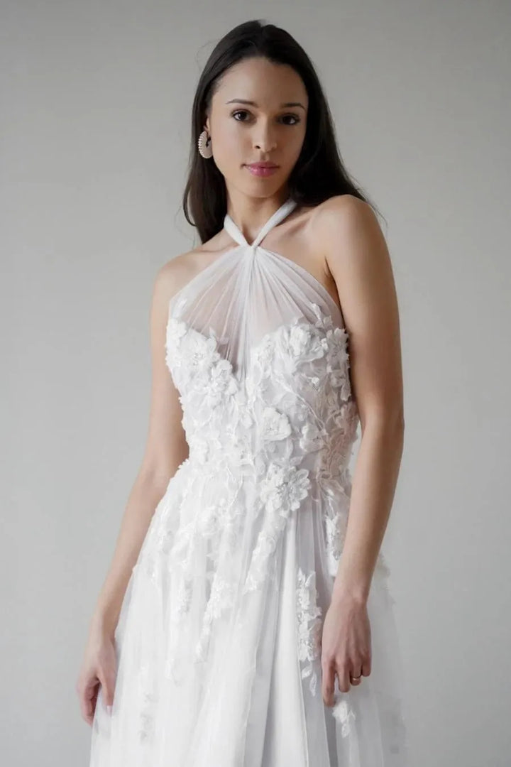 close up of willowby alessandra nude tulle a-line wedding dress showing a sheer halter style neckline and floral motifs