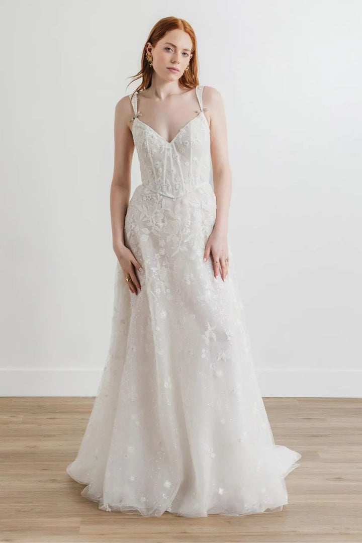 full front of willowby by watters nerissa ivory net sheath wedding dress featuring a v neckline with tapered straps, and floral embroidery