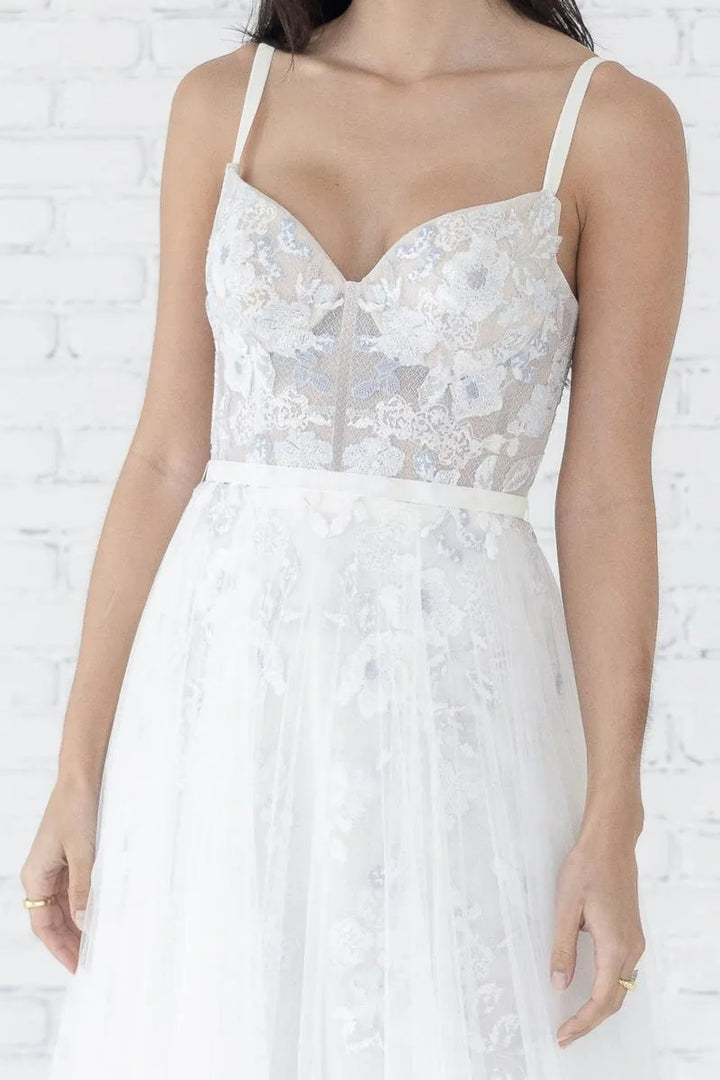 White lace dress with thin straps on a white background