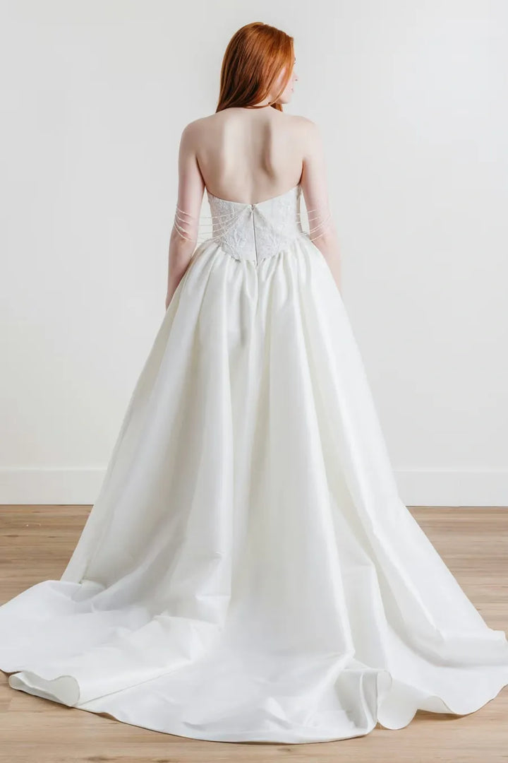 full back of willowby goldie ivory lace sheath wedding dress with a matching satin overskirt