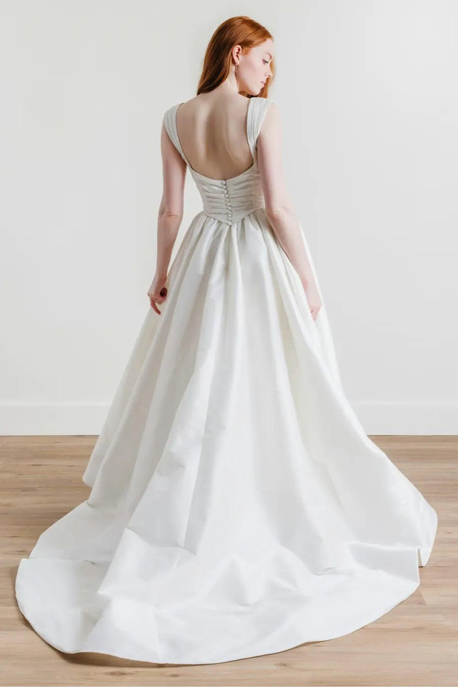 full back of willowby ingrid ivory dupioni a-line wedding dress with a drop waist and flower pin