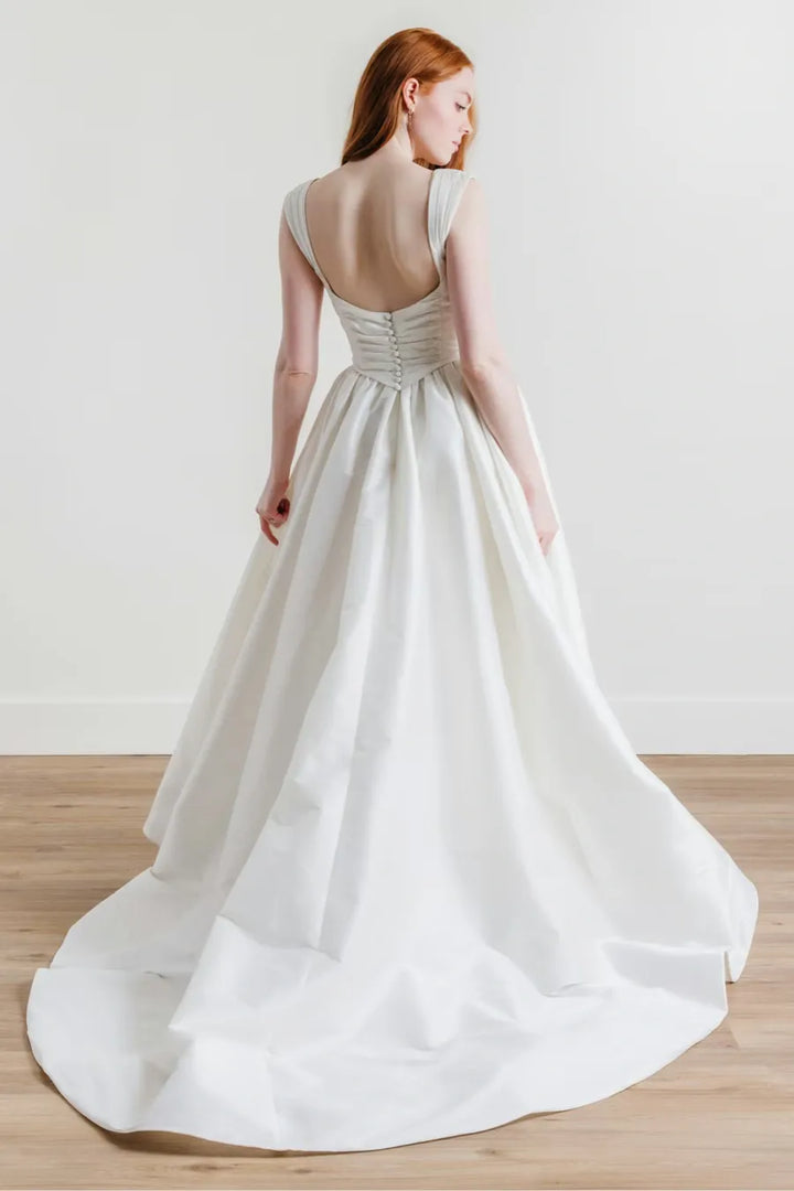 full back of willowby ingrid ivory dupioni a-line wedding dress with a drop waist and flower pin