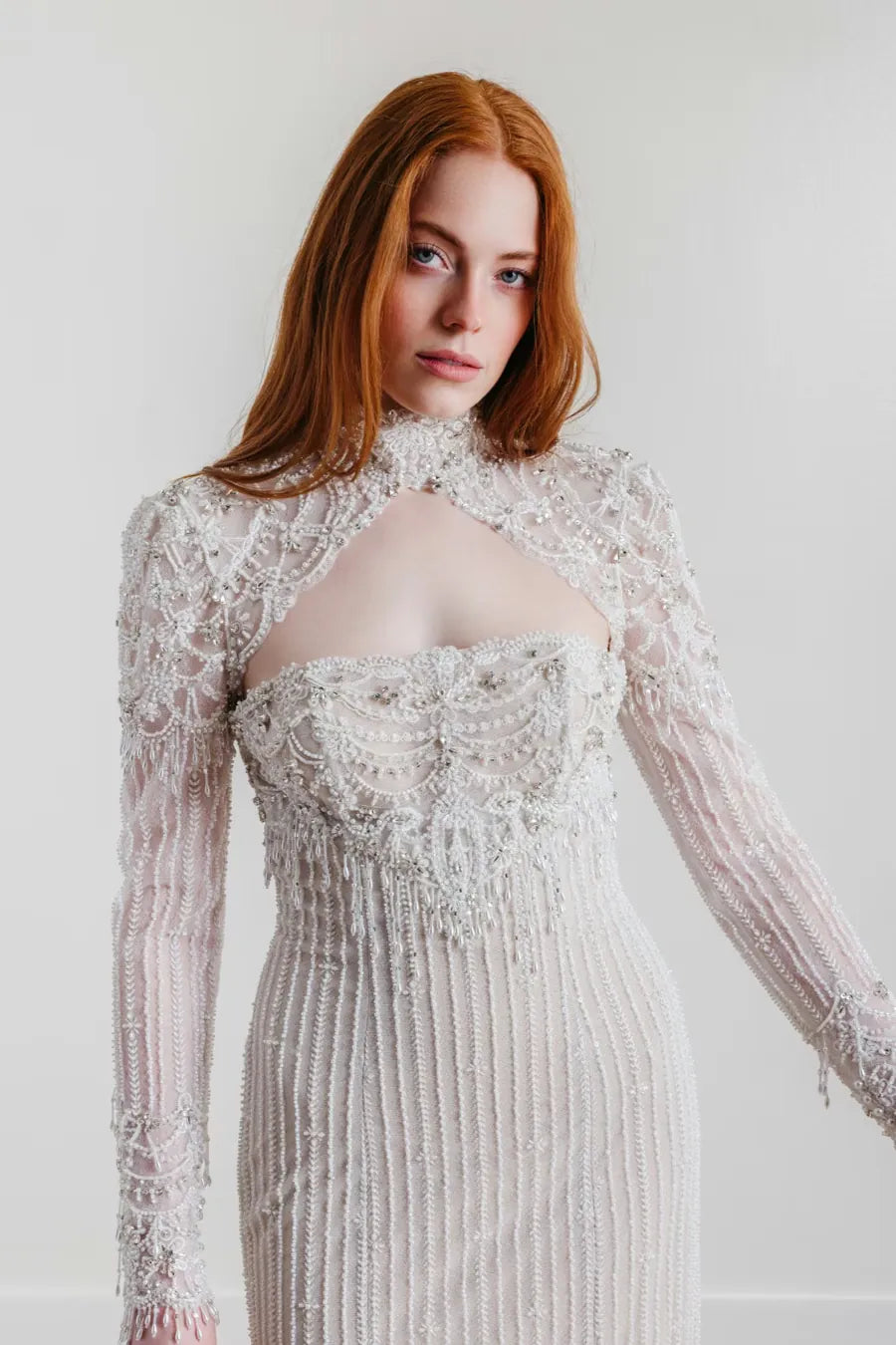 close up of willowby jade silver beaded sheath wedding dress with a matching long sleeve topper
