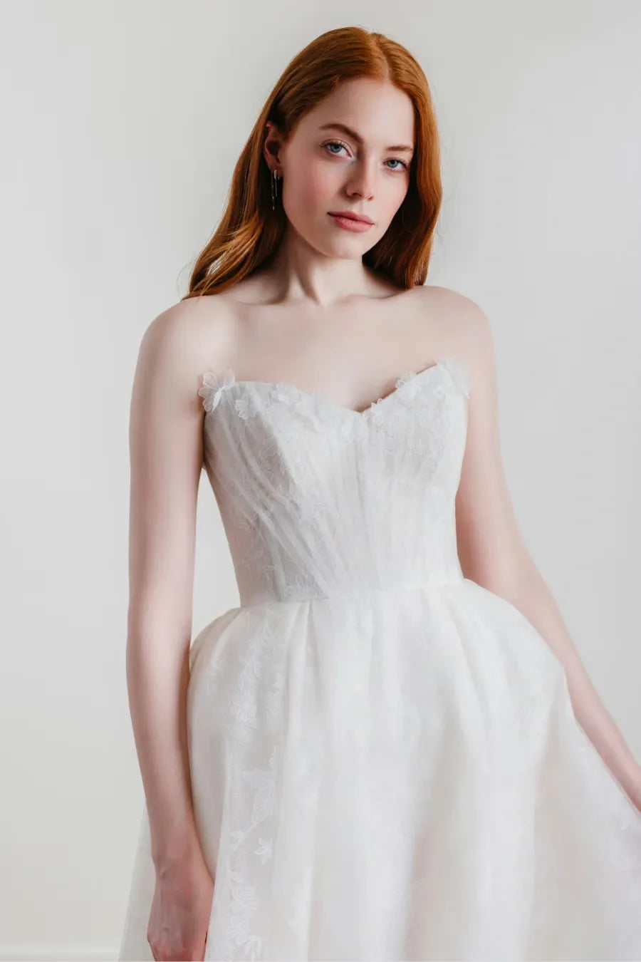 close up of willowby palmer ivory embroidered tulle ball gown with a strapless sweetheart neckline