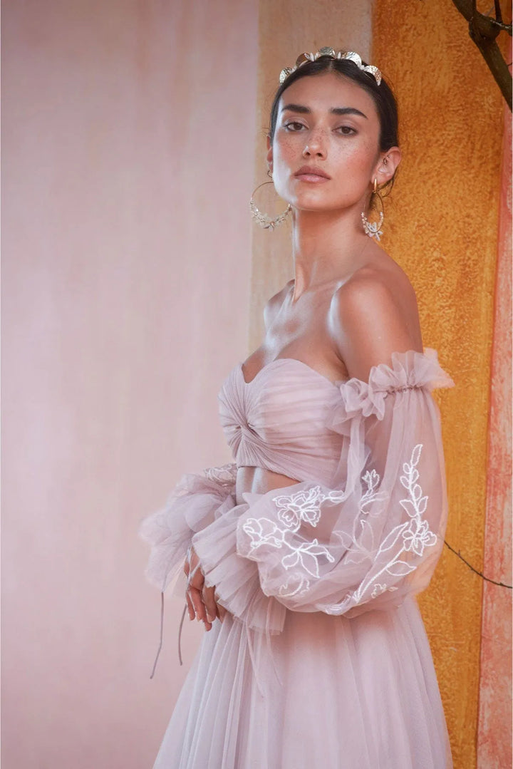 close up of willowby by watters renae and innika blush tulle a-line bridal set showing the puffed long sleeves with floral embroidery 