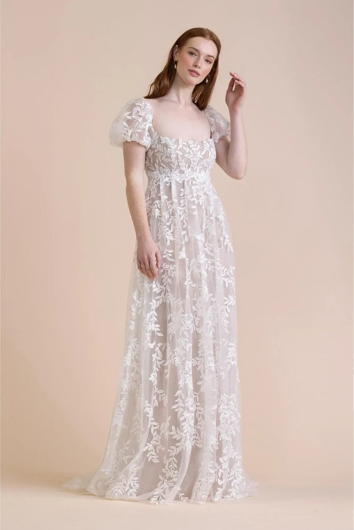 full front of willowby by watters simone nude lace sheath wedding dress with a square neckline and short puffed sleeves