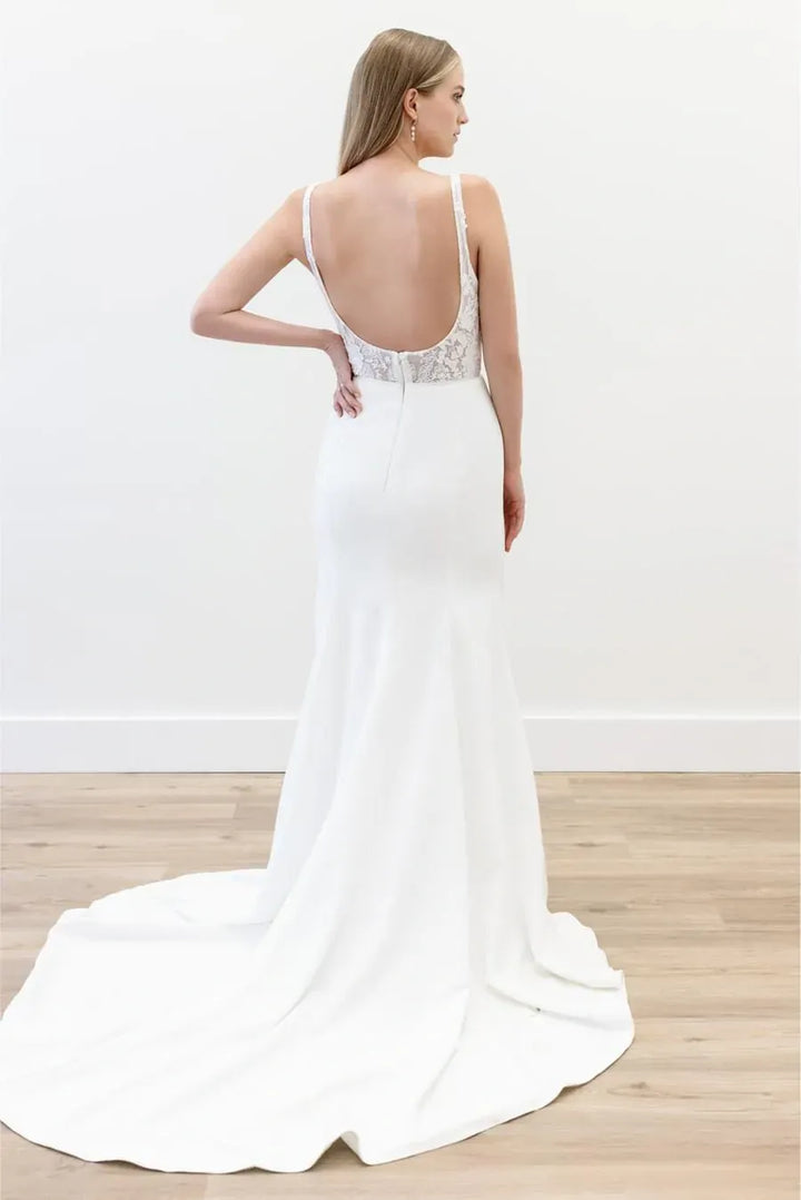 full back of willowby by watters taylie ivory crepe fitted wedding dress featuring an open back and short train