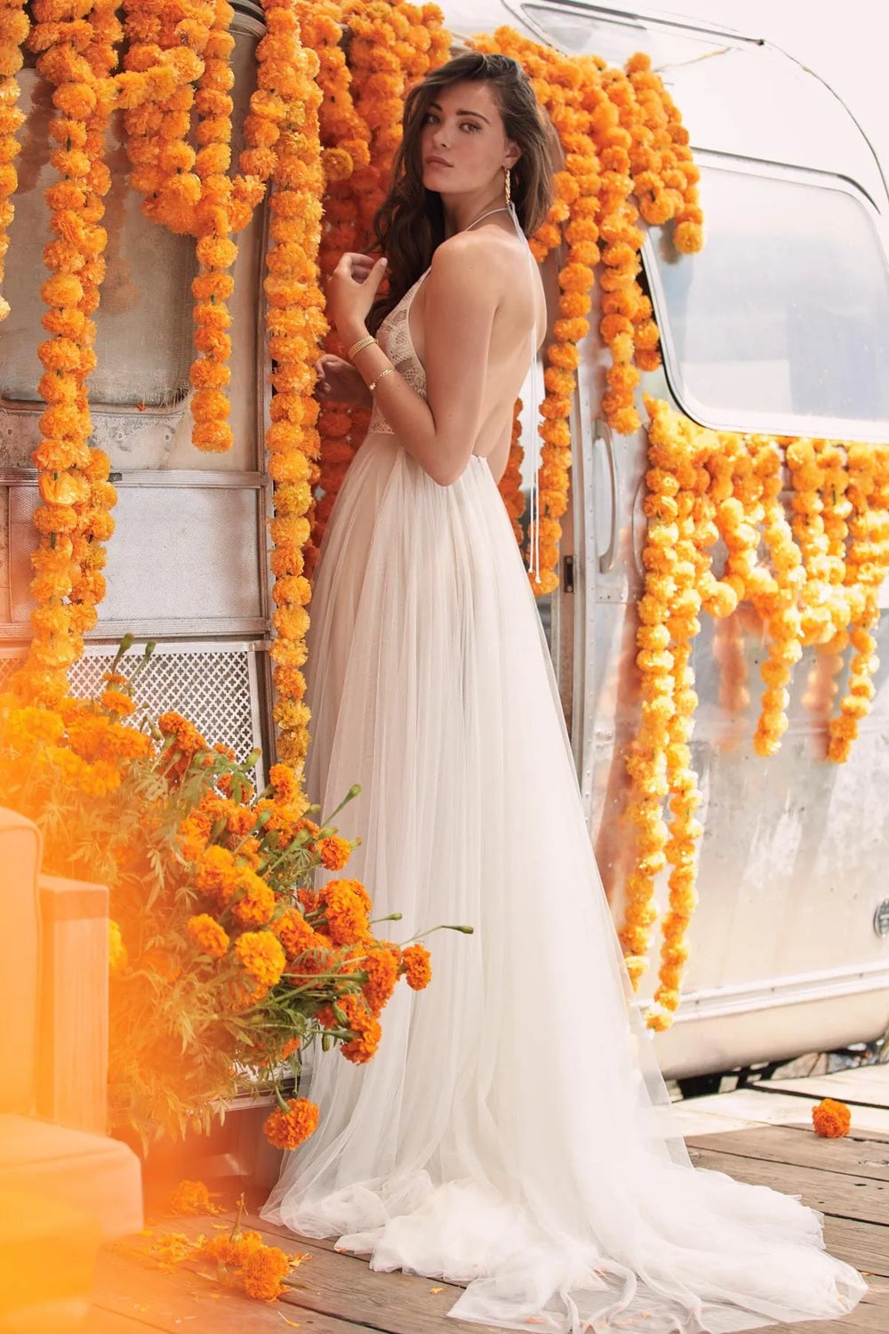back of willowby by watters kinney champagne tulle a-line wedding dress, showing the full back with a layered tulle skirt
