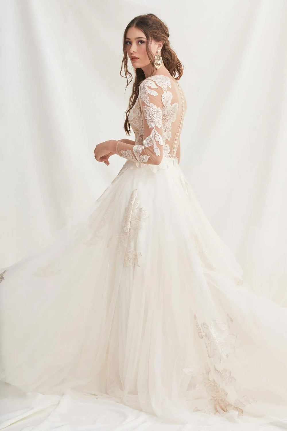 White wedding dress with lace detailing on a white background