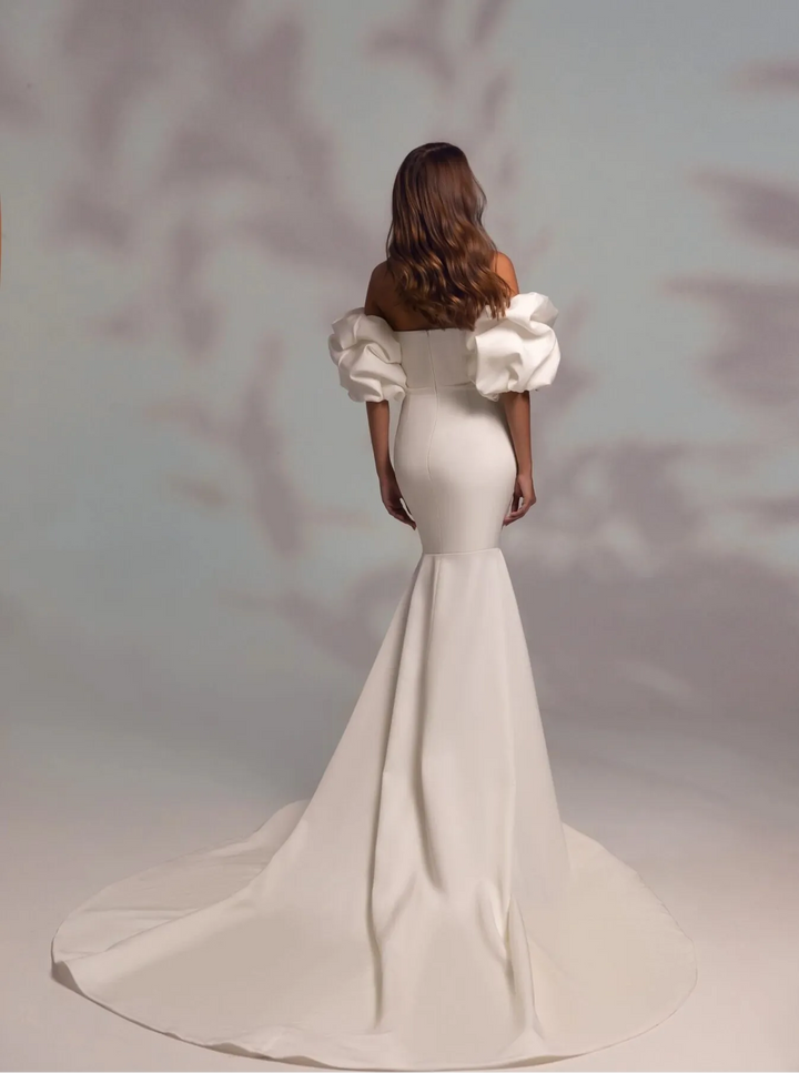 back of wona noble ivory mikado fit and flare wedding dress showing the flared skirt and chapel length train