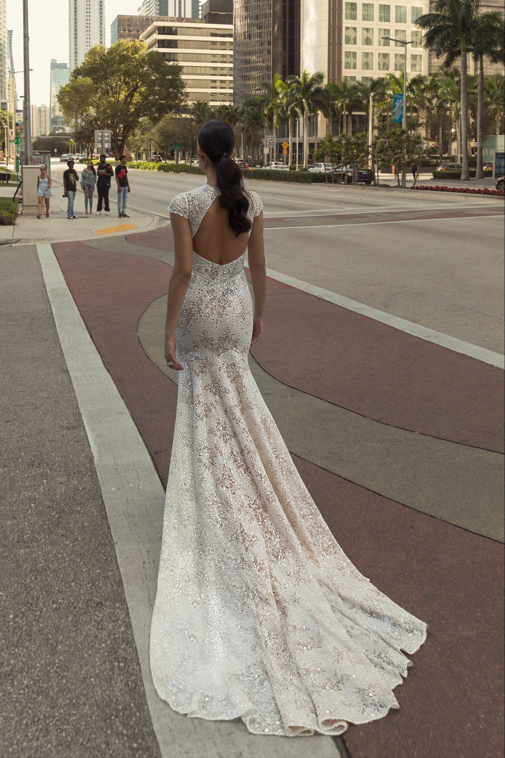 full back of wona olivia ivory lace fit and flare wedding dress with an open back and short train