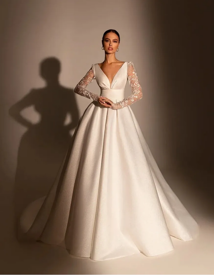 full front of wona riccarda ivory sparkle lace a-line wedding dress with a v neckline and long sleeves