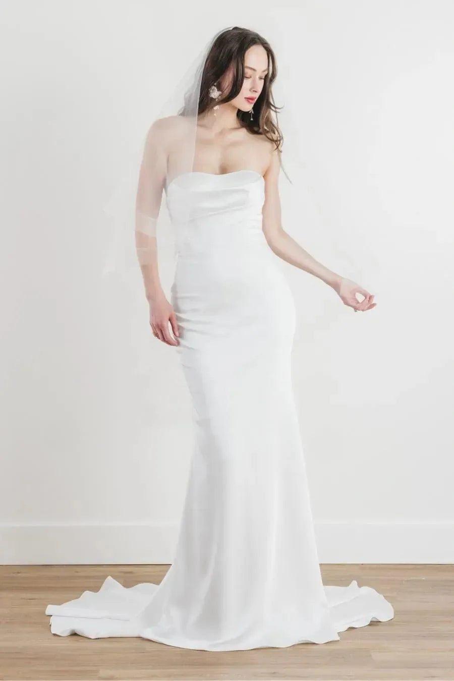 front of locket by watters dulcinea ivory satin fitted wedding dress with a strapless sweetheart neckline