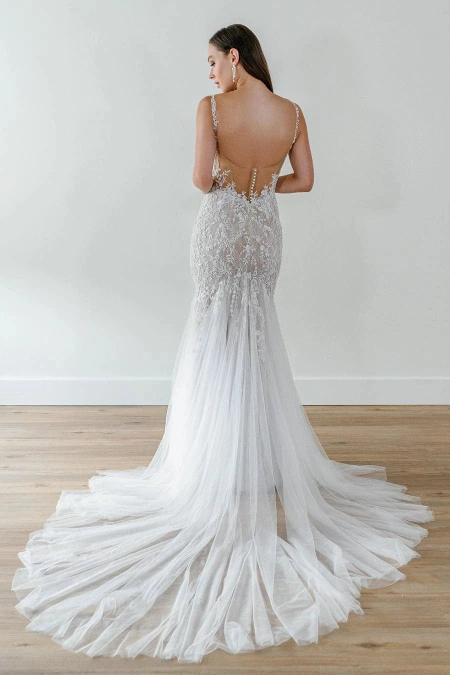 back of watters looksy champagne tulle fit and flare wedding dress with sheer back and wispy chapel length train