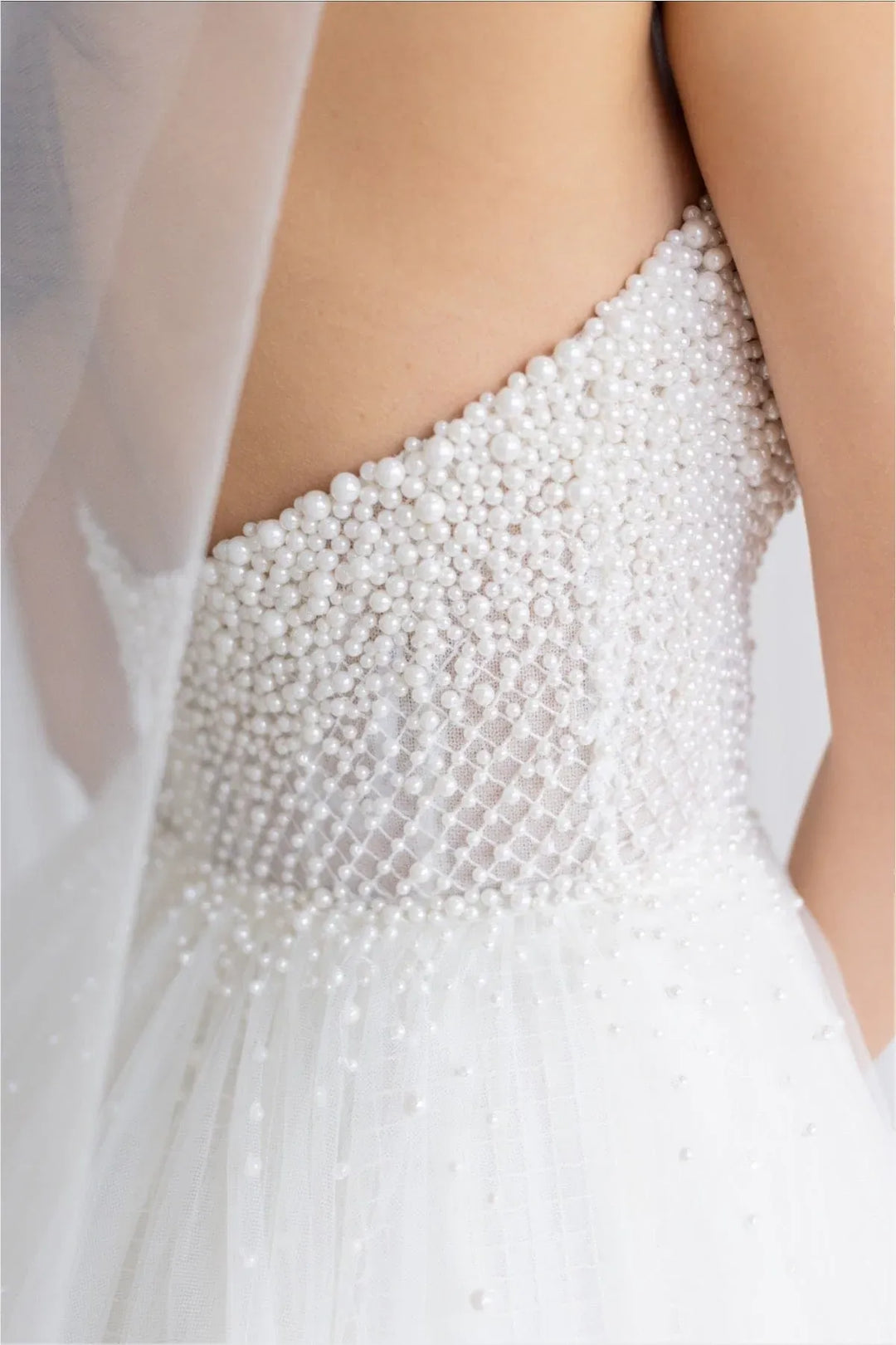 close up of locket by watters maeve ivory tulle a-line wedding dress featuring the pearl covered bodice