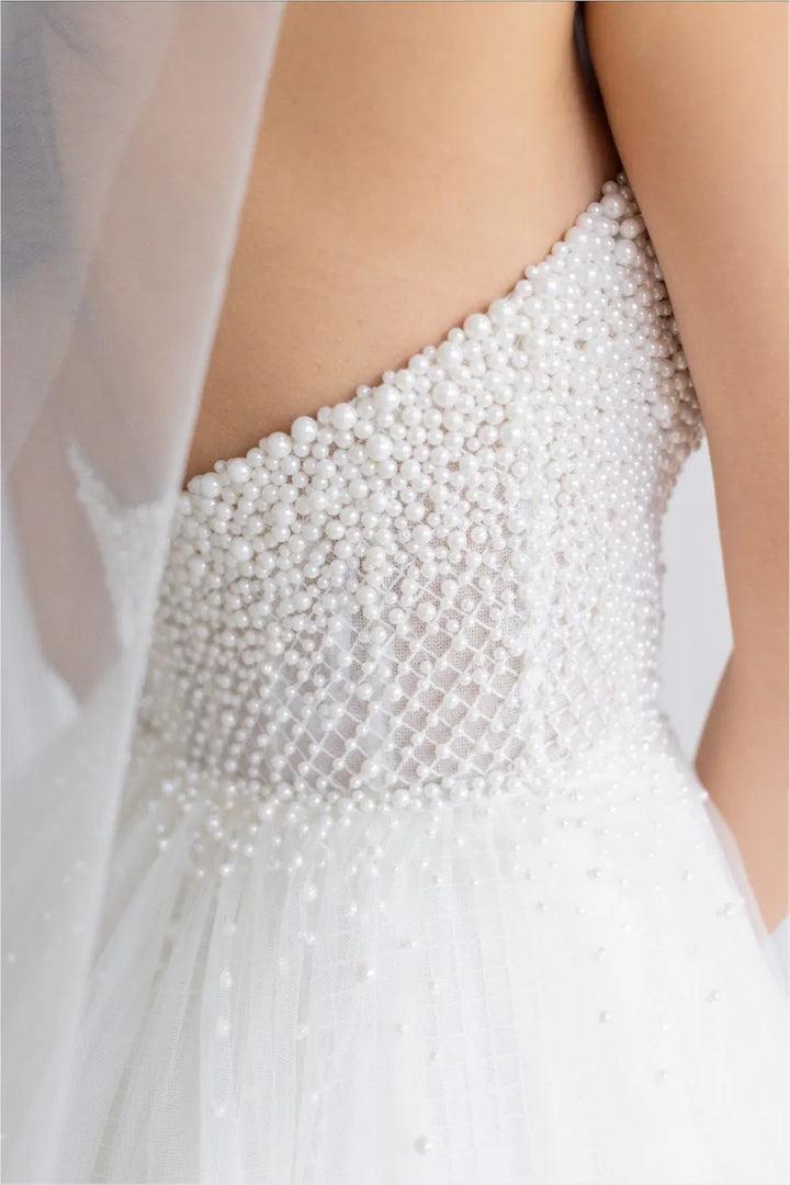 close up of locket by watters maeve ivory tulle a-line wedding dress featuring the pearl covered bodice