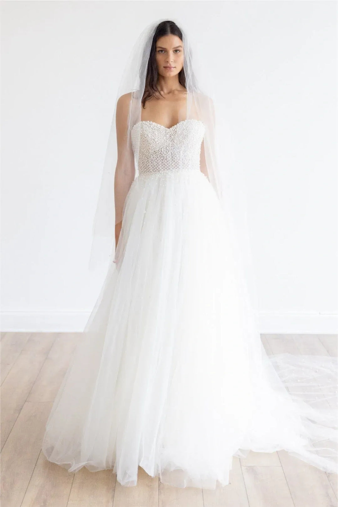 full front of locket by watters maeve ivory tulle a-line wedding dress featuring a pearl covered bodice with a sweetheart neckline, and an airy skirt